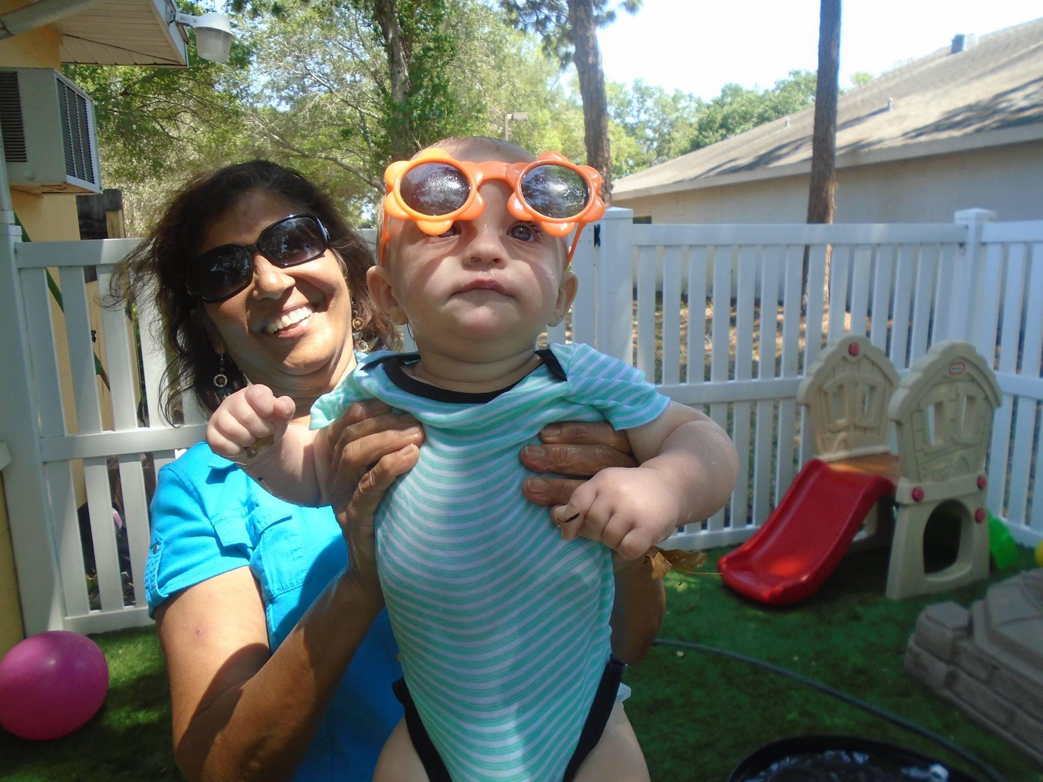 Adult and young child together in an outdoor play area at Toad Hall