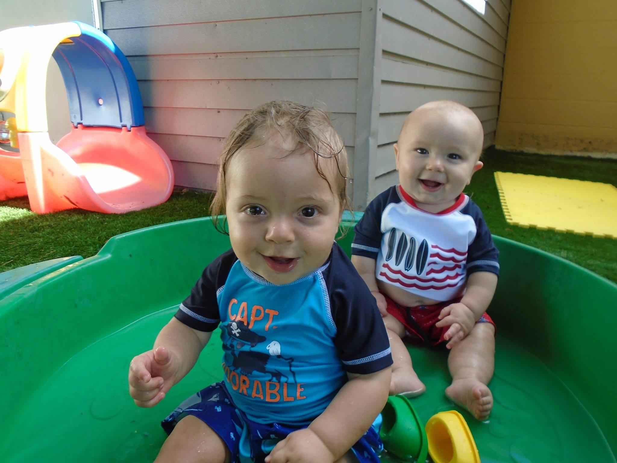 Two young children enjoying outdoor play at Toad Hall